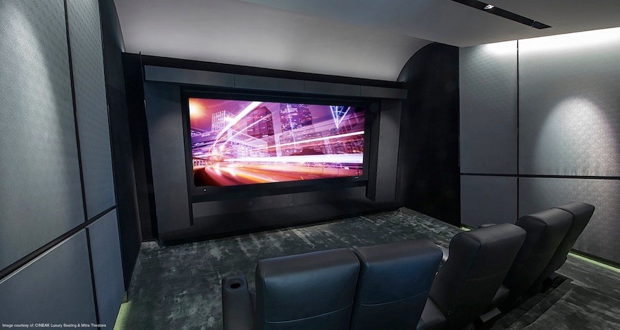 high-end home theater featuring projection screen and plush leather chairs